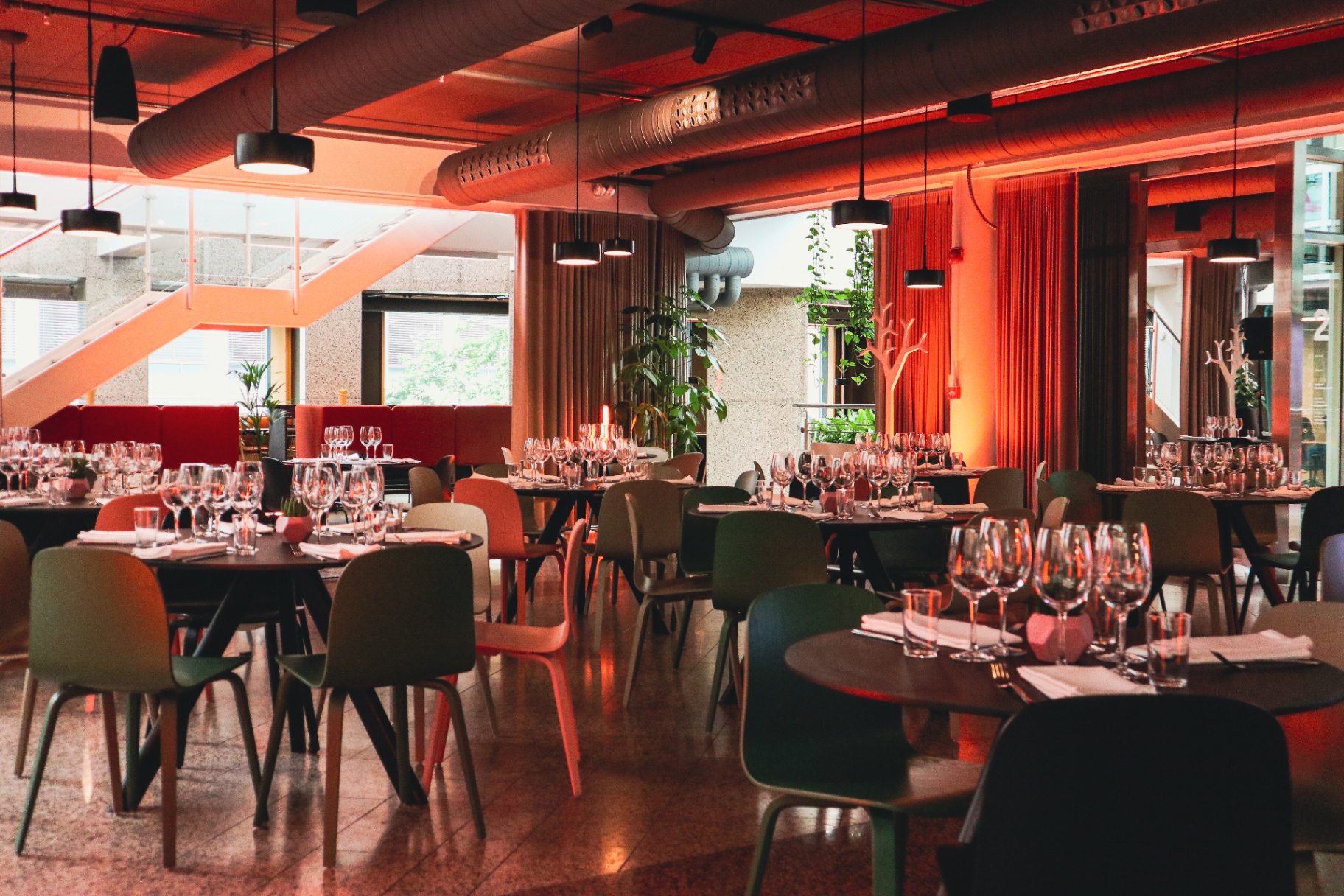The Hive set for a dinner with green chairs and warm lighting